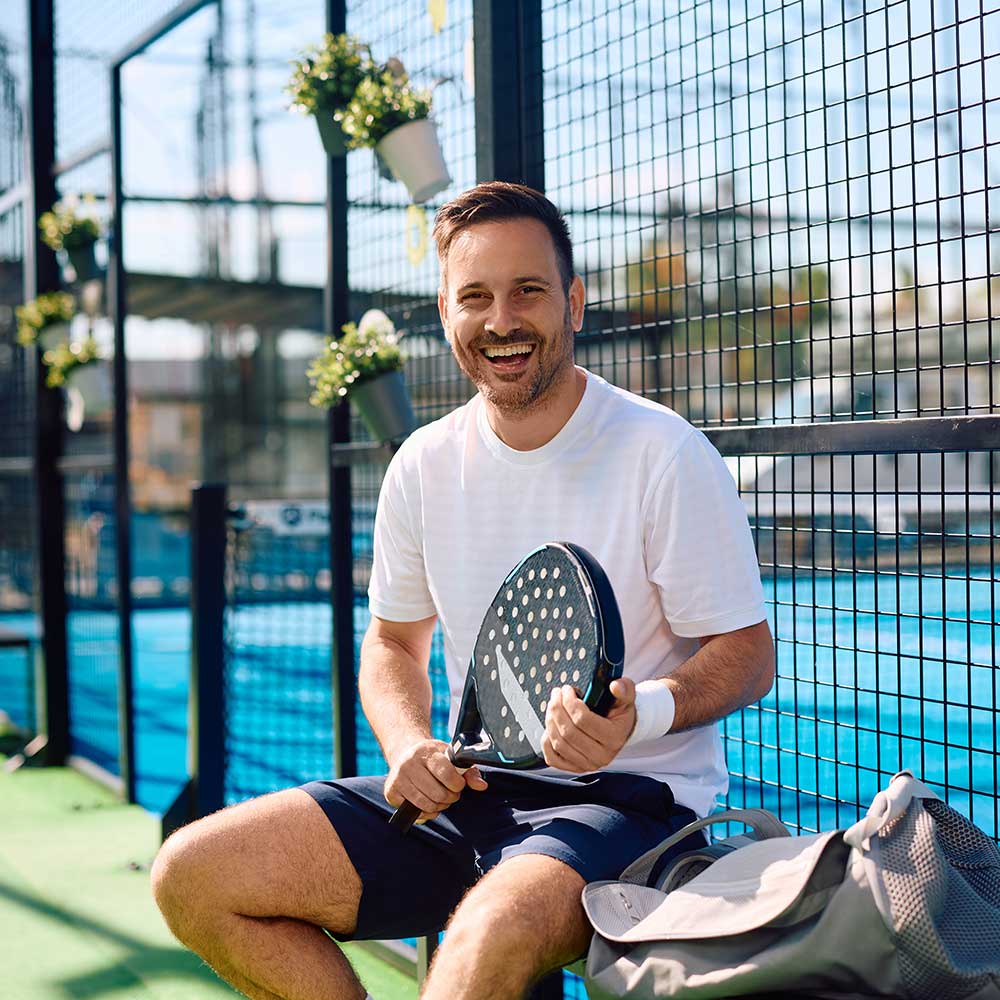 happy-paddle-tennis-player-on-an-outdoor-court-loo-MX89ERL