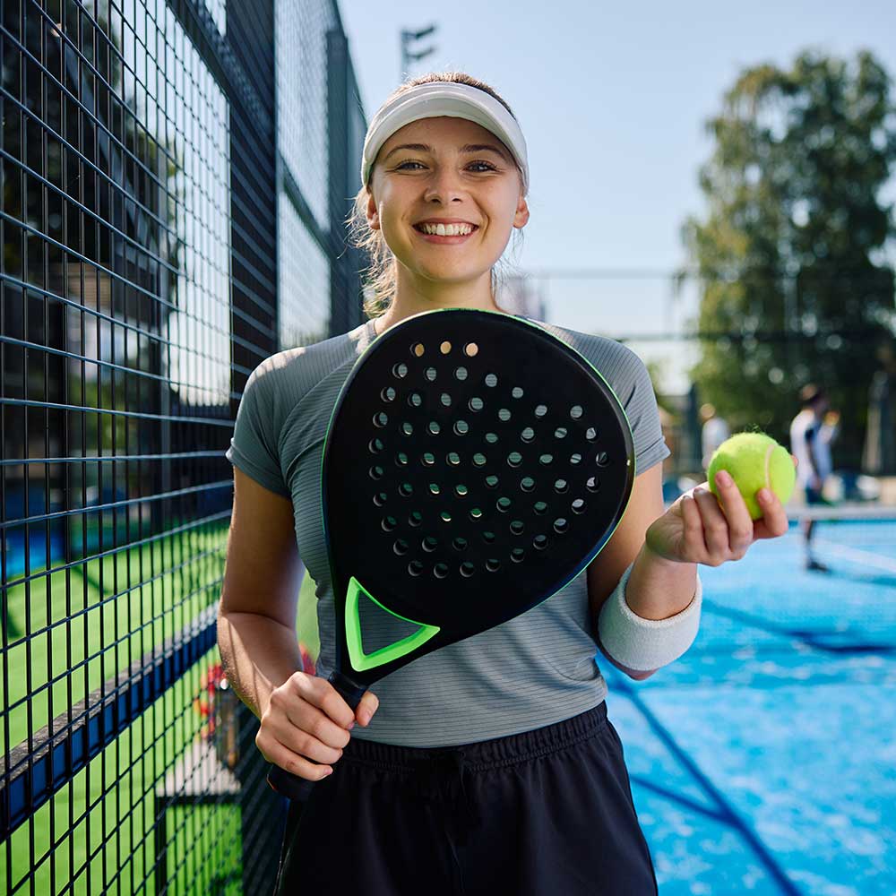 young-athletic-woman-playing-paddle-tennis-on-outd-WUP7D6S
